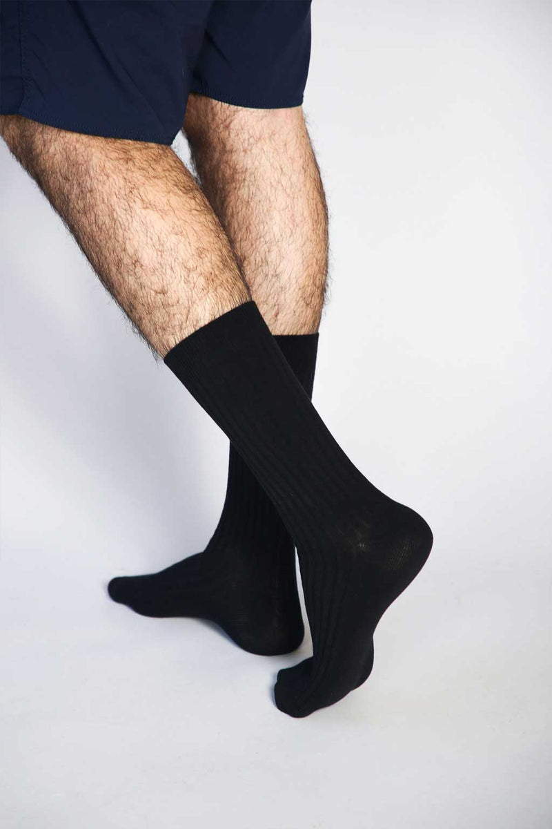 Close up photo of man’s feet wearing Tailored Union dress socks