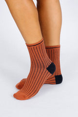 Close up photo of woman's feet wearing Tailored Union striped ankle socks