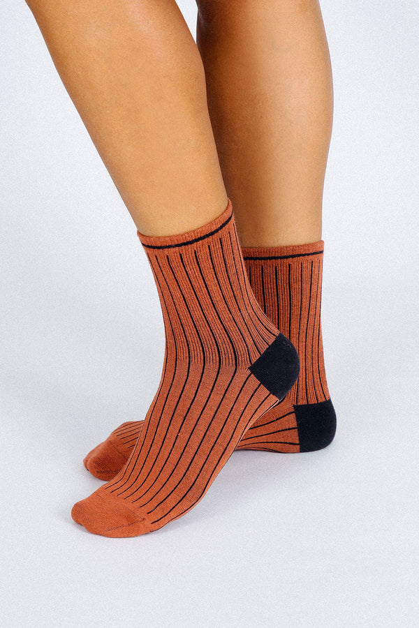 Close up photo of woman's feet wearing Tailored Union striped ankle socks