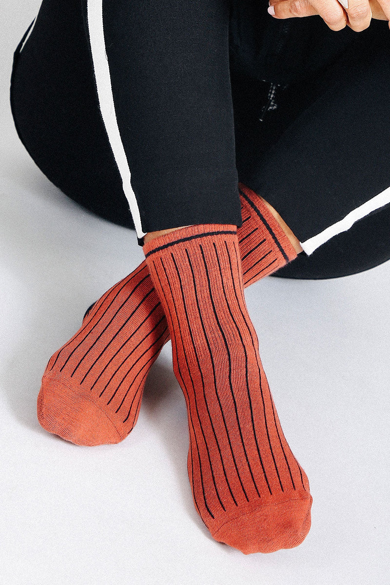 Close up photo of woman's feet wearing Tailored Union striped ankle socks