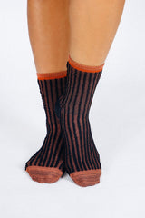 Close up photo of woman's feet wearing Tailored Union striped ankle socks