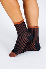 Close up photo of woman's feet wearing Tailored Union striped ankle socks
