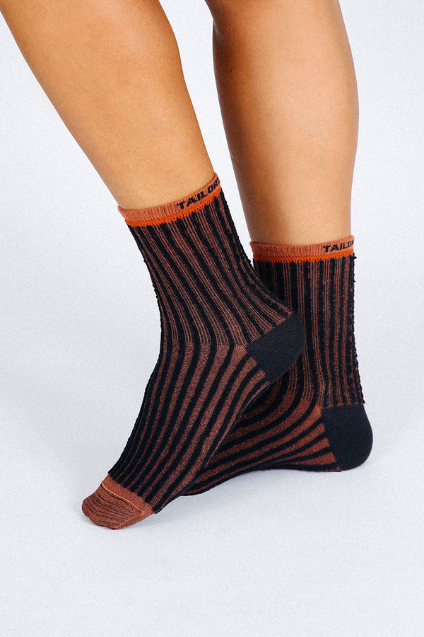 Close up photo of woman's feet wearing Tailored Union striped ankle socks