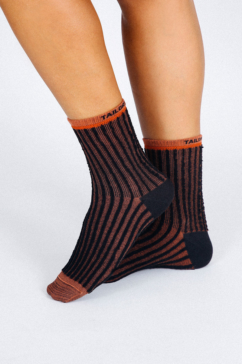 Close up photo of woman's feet wearing Tailored Union striped ankle socks