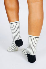 Close up photo of woman's feet wearing Tailored Union striped ankle socks