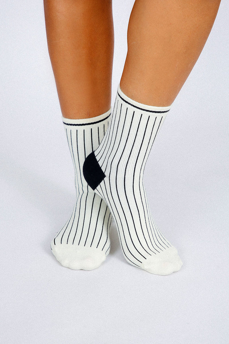 Close up photo of woman's feet wearing Tailored Union striped ankle socks