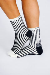Close up photo of woman's feet wearing Tailored Union striped ankle socks
