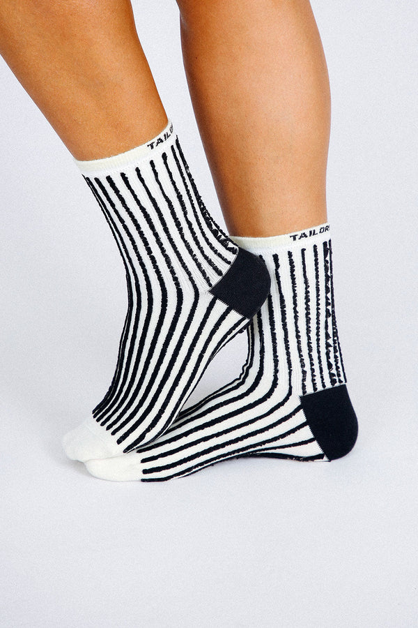 Close up photo of woman's feet wearing Tailored Union striped ankle socks