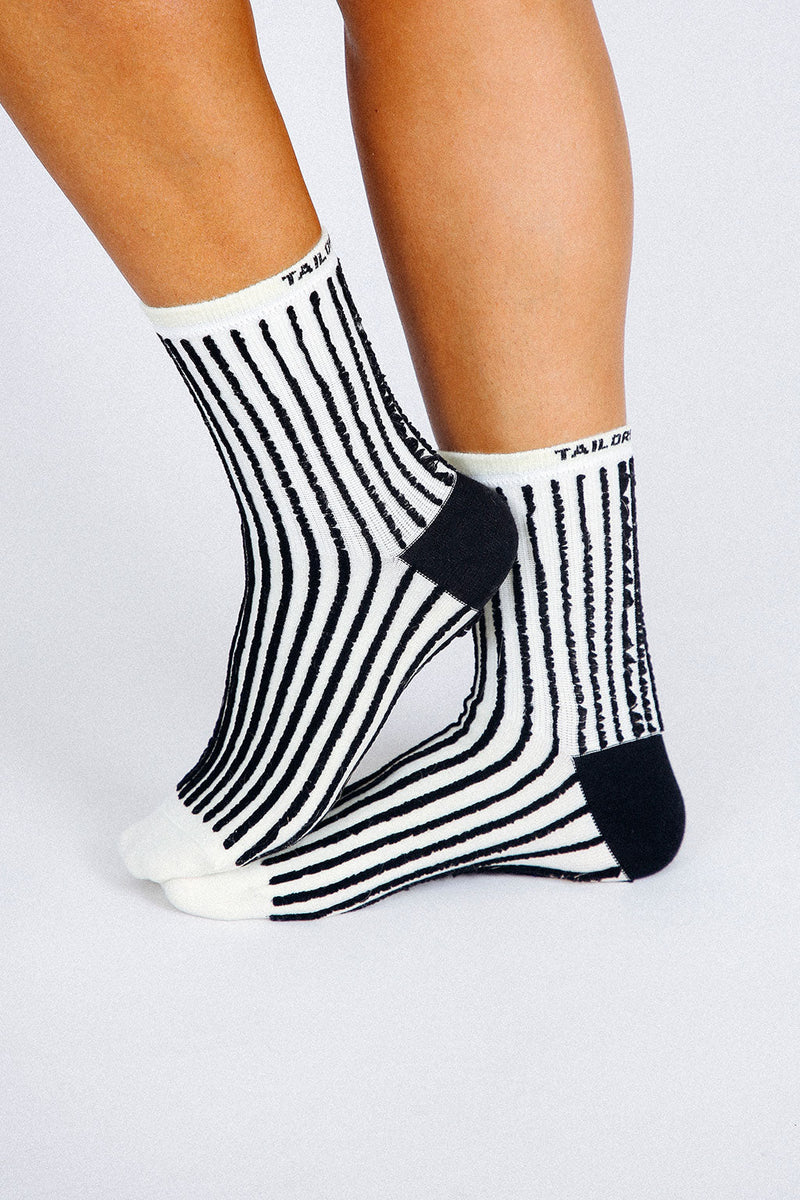 Close up photo of woman's feet wearing Tailored Union striped ankle socks